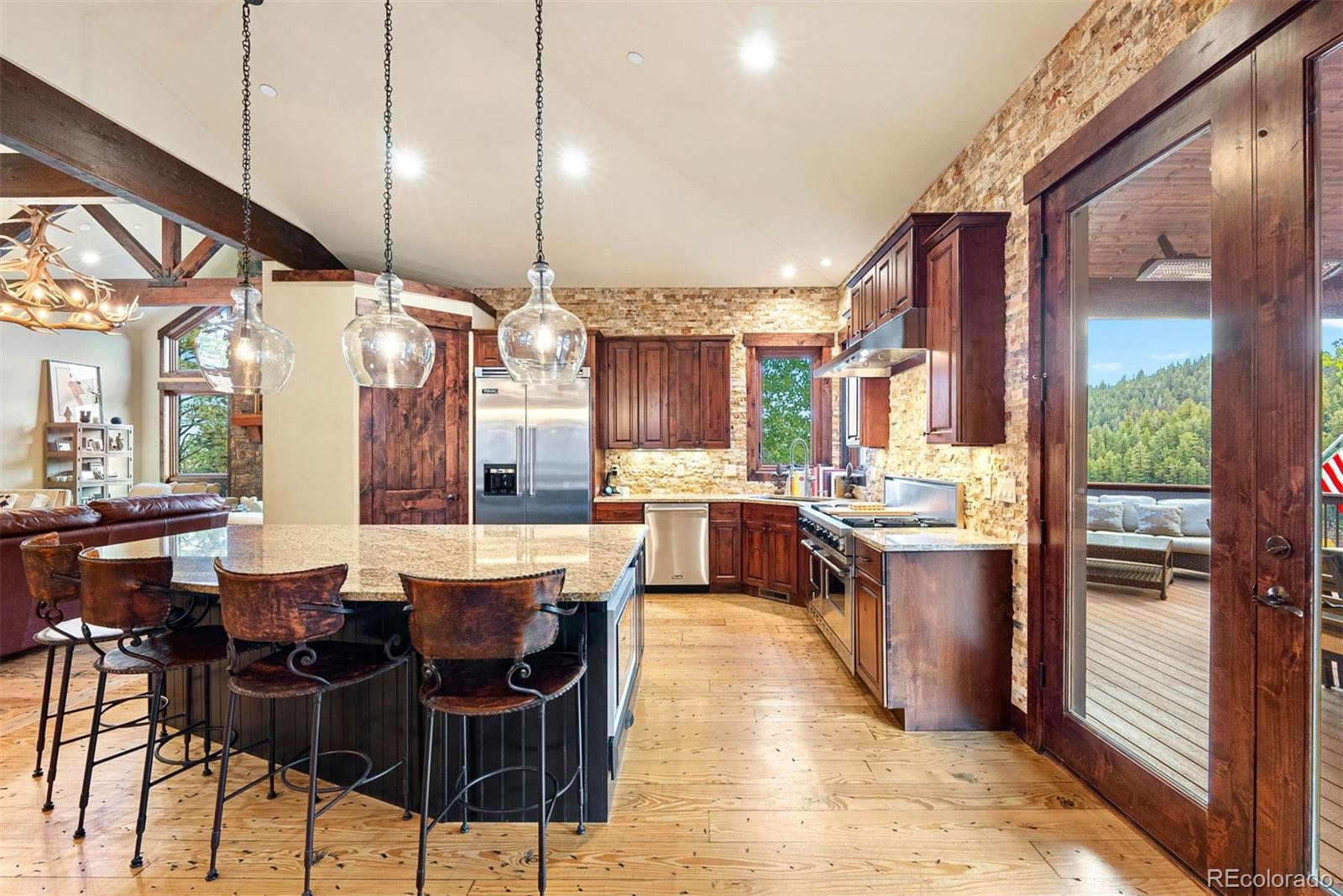 610 Clear Creek Road Evergreen, CO 80439 - Photo 15 of 50 a large kitchen with a table and chairs