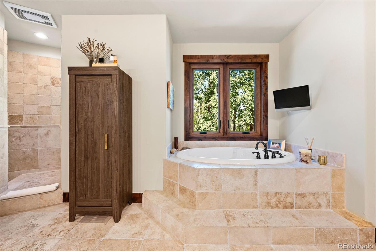 610 Clear Creek Road Evergreen, CO 80439 - Photo 20 of 50 a bathroom with a sink and a mirror