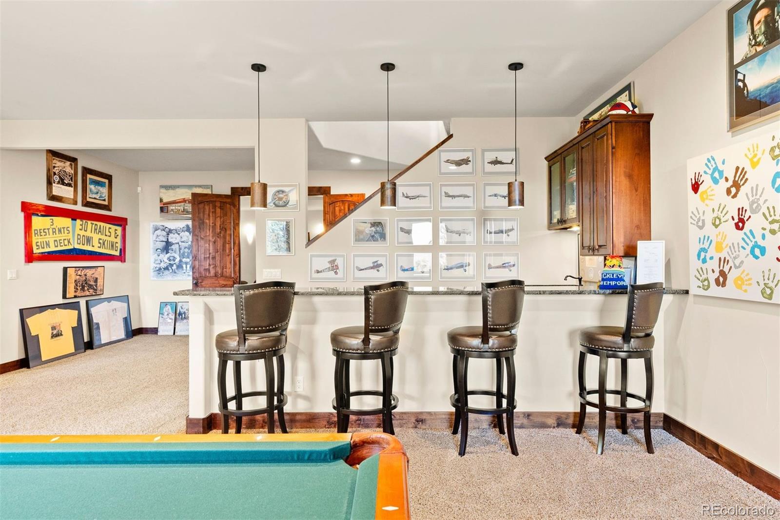 610 Clear Creek Road Evergreen, CO 80439 - Photo 30 of 50 a kitchen with stainless steel appliances kitchen island granite countertop a table and chairs in it