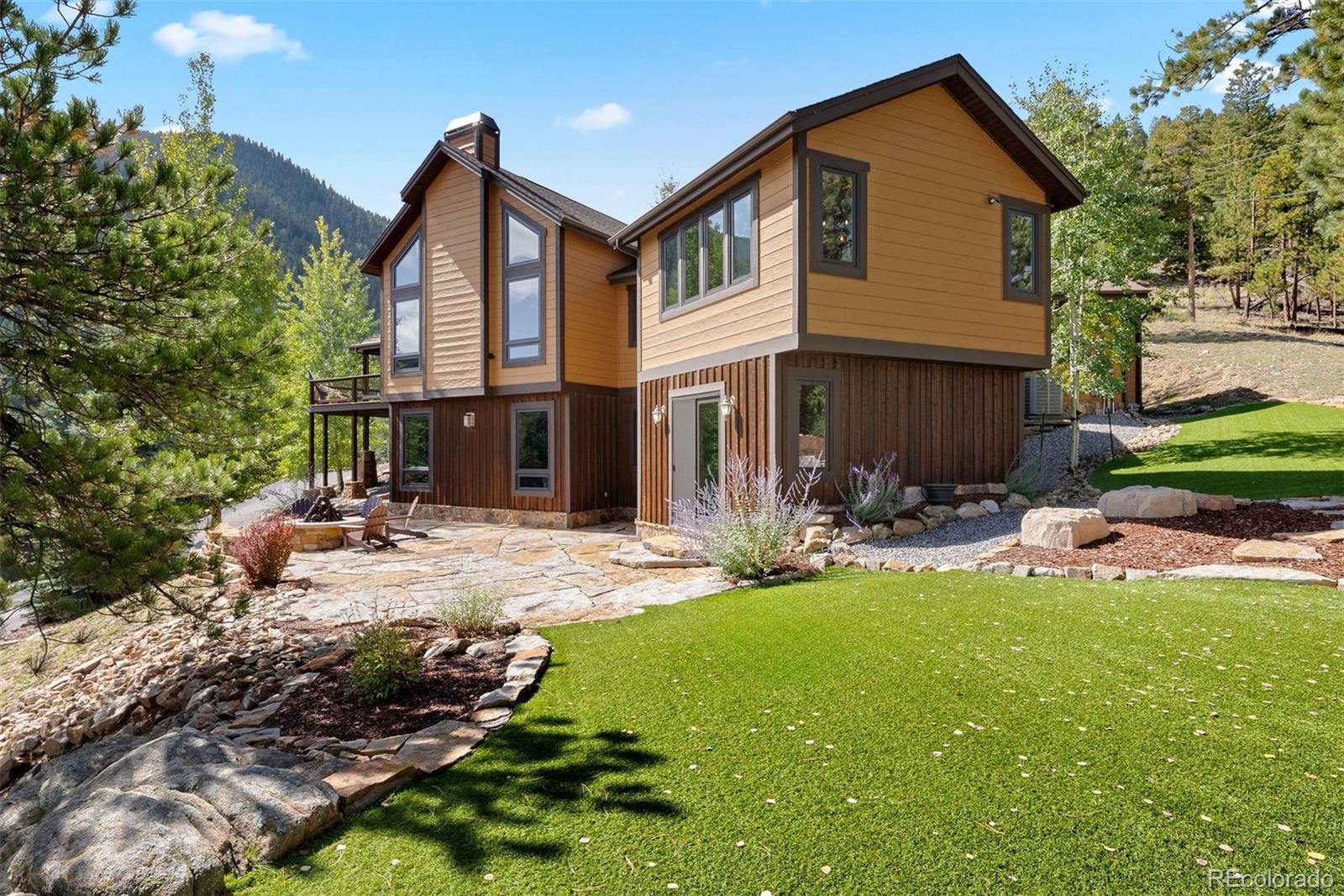 610 Clear Creek Road Evergreen, CO 80439 - Photo 3 of 50 a view of a house with backyard and sitting area
