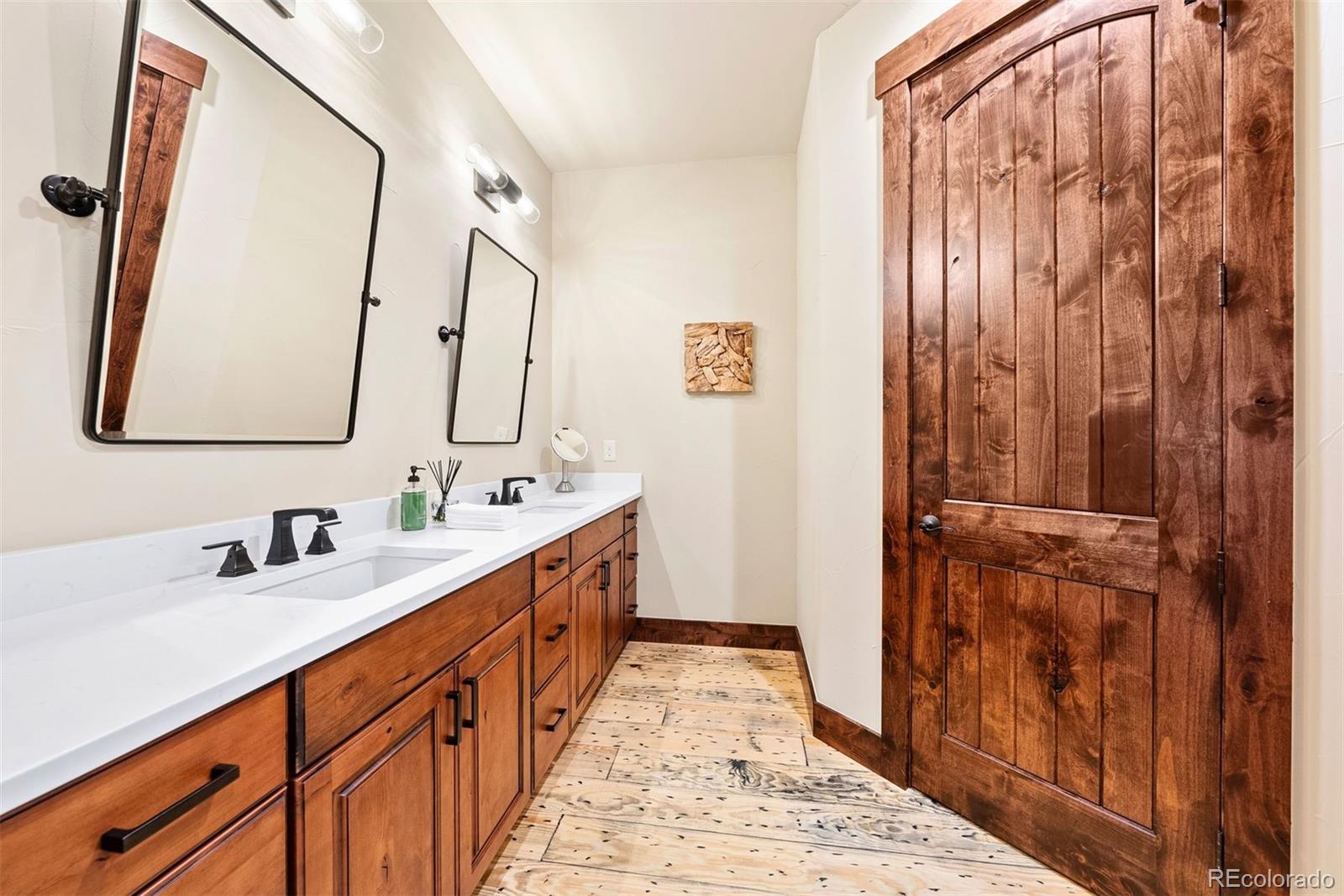 610 Clear Creek Road Evergreen, CO 80439 - Photo 35 of 50 a bathroom with a double vanity sink and mirror