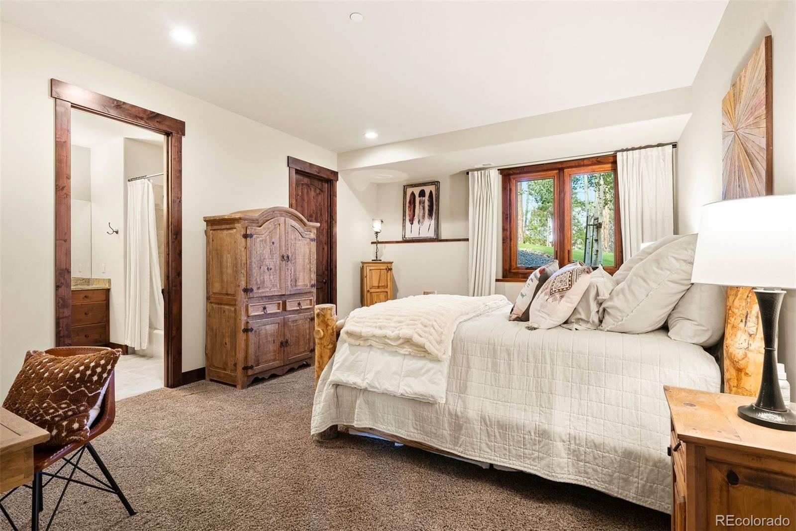 610 Clear Creek Road Evergreen, CO 80439 - Photo 36 of 50 a bedroom with a bed and a couch