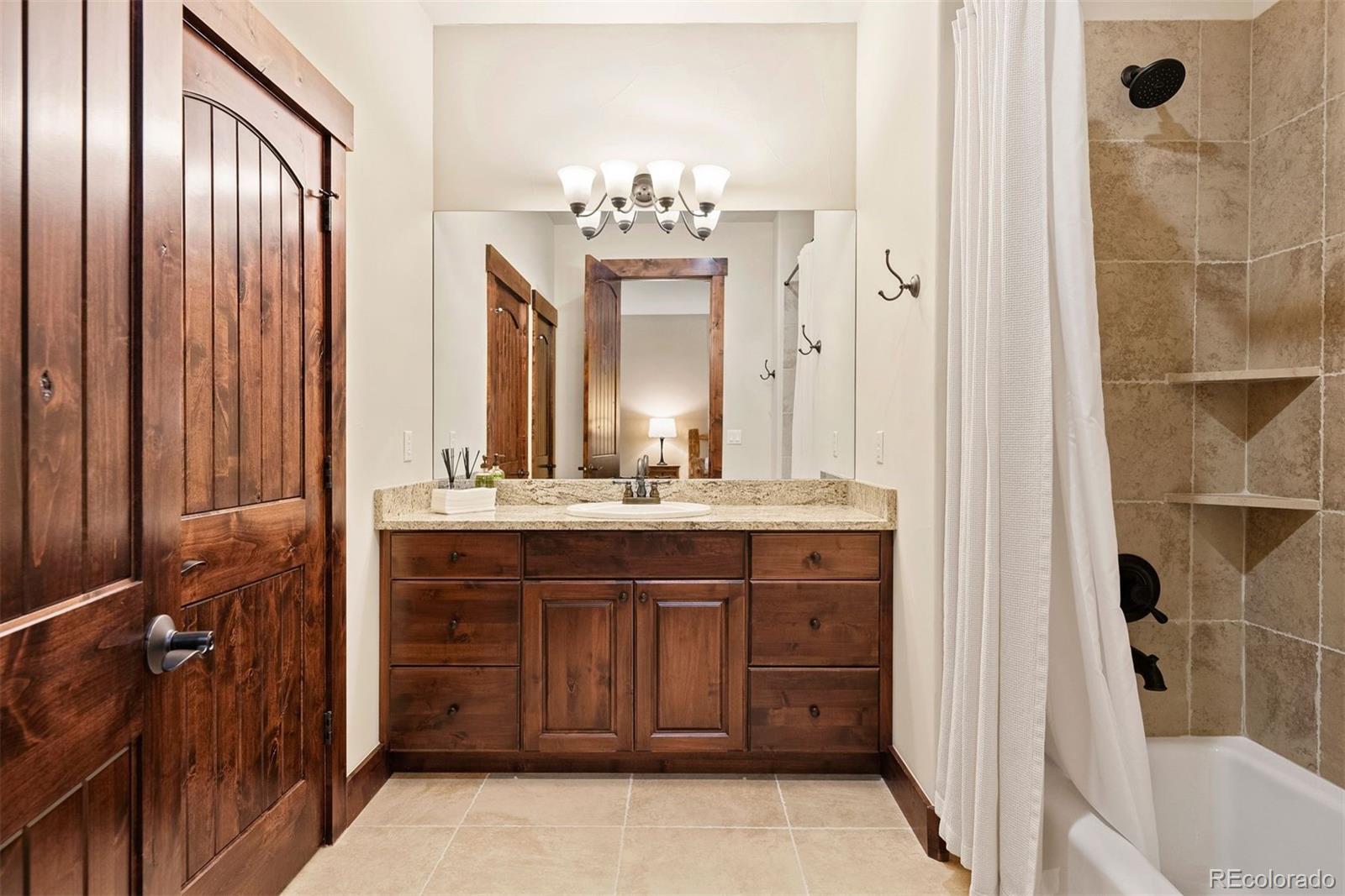 610 Clear Creek Road Evergreen, CO 80439 - Photo 38 of 50 a bathroom with a double vanity sink and a mirror
