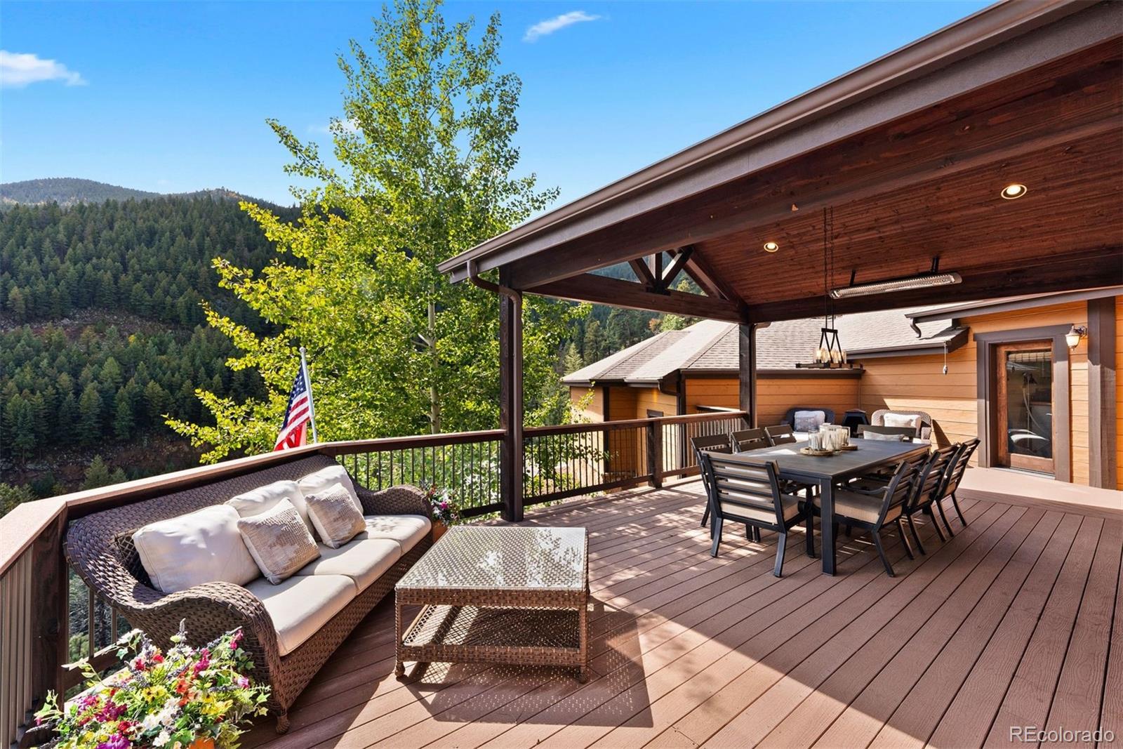 610 Clear Creek Road Evergreen, CO 80439 - Photo 41 of 50 an outdoor sitting area with furniture and wooden floor