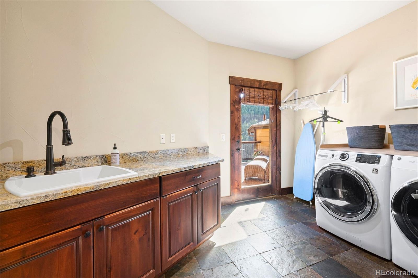 610 Clear Creek Road Evergreen, CO 80439 - Photo 43 of 50 a kitchen with a sink and a washer dryer