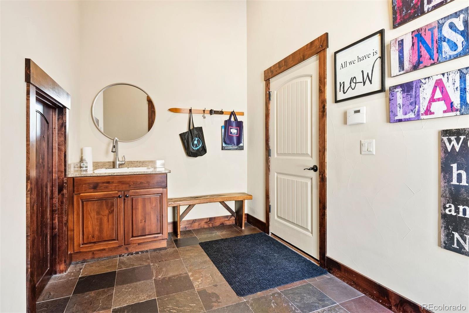 610 Clear Creek Road Evergreen, CO 80439 - Photo 44 of 50 a bathroom with a sink a mirror and a shower