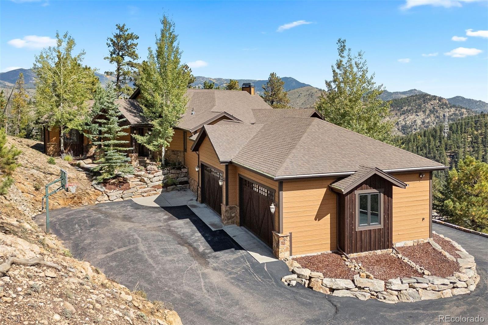 610 Clear Creek Road Evergreen, CO 80439 - Photo 45 of 50 a view of a house with a yard