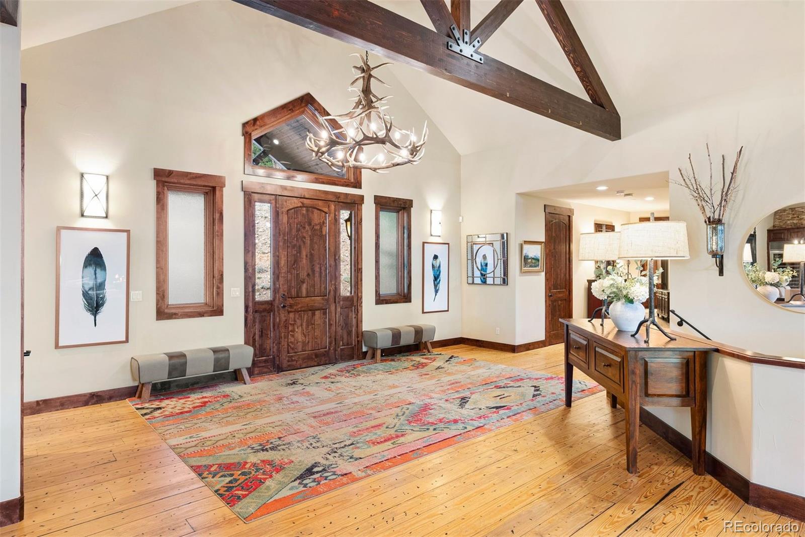 610 Clear Creek Road Evergreen, CO 80439 - Photo 5 of 50 a view of a livingroom with a dinning area hardwood floor and a ceiling fan