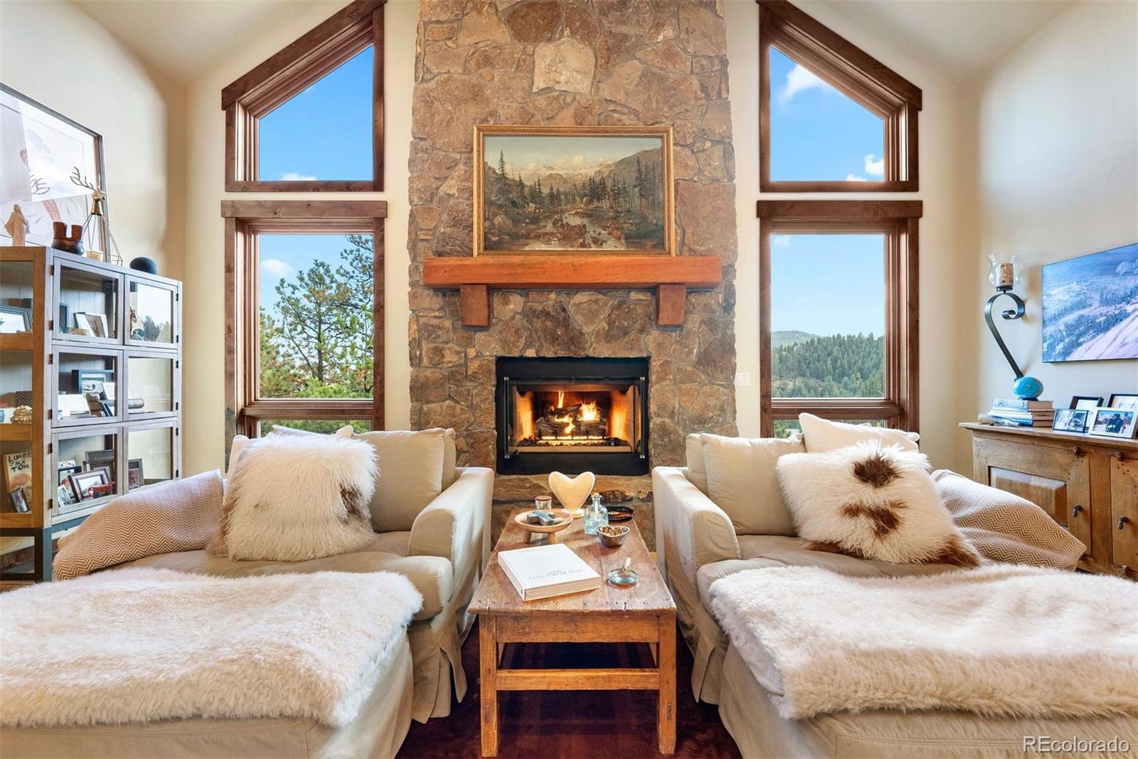 610 Clear Creek Road Evergreen, CO 80439 - Photo 10 of 50 a bedroom with a bed and a fireplace