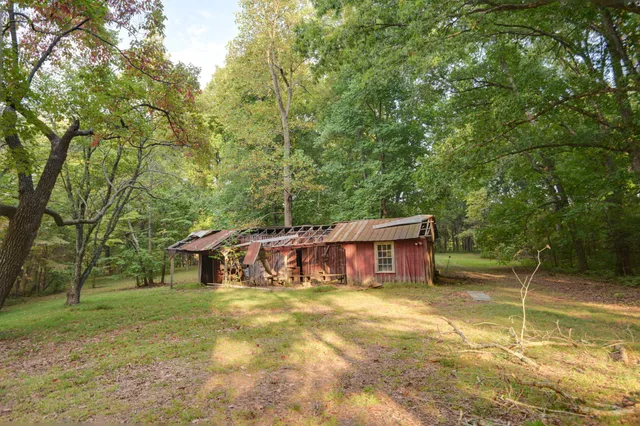 a view of an empty room with a fireplace and a window