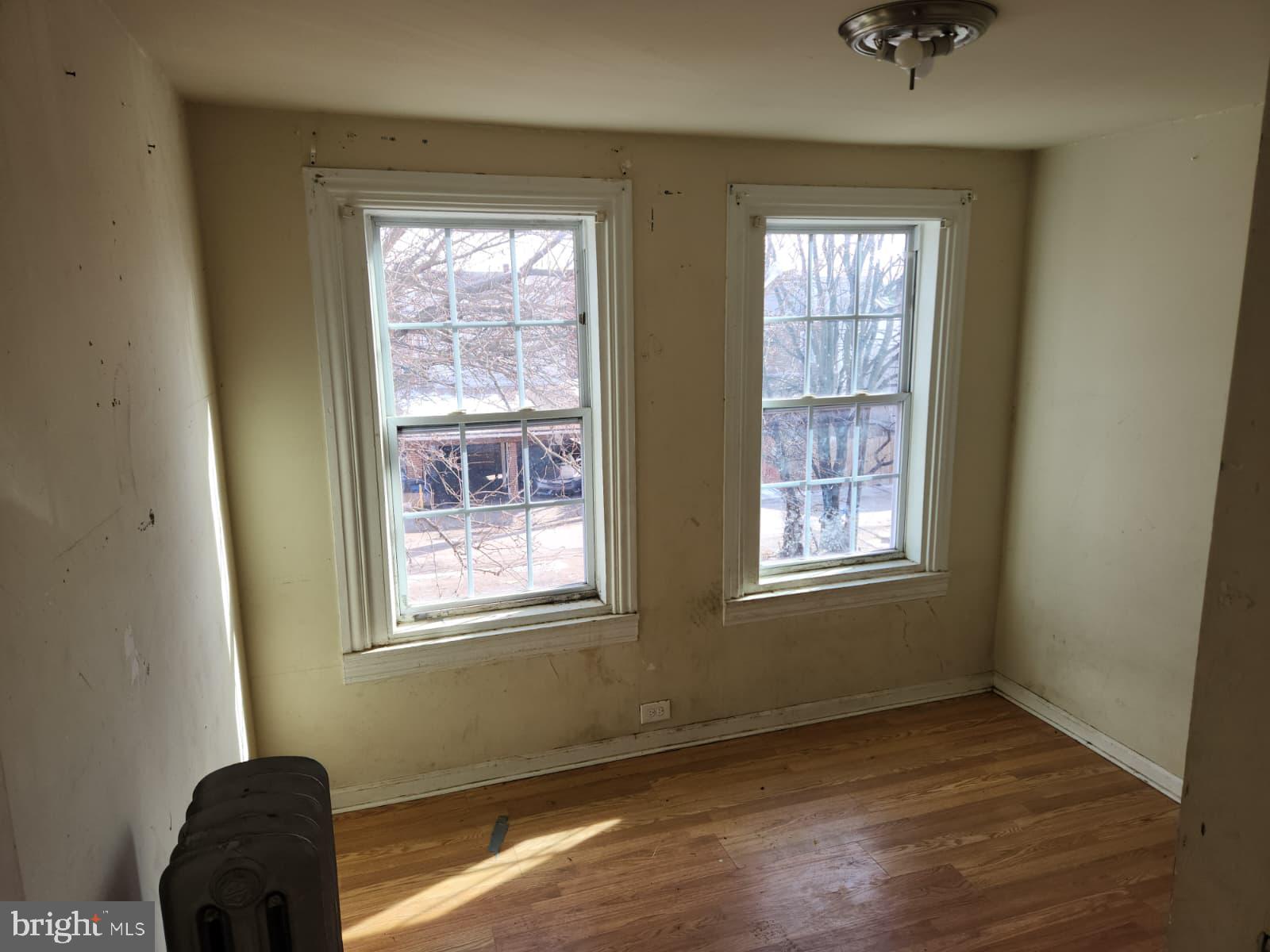 648 Kohn Street Norristown, PA 19401 - Photo 25 of 39 a view of an empty room with wooden floor and a window
