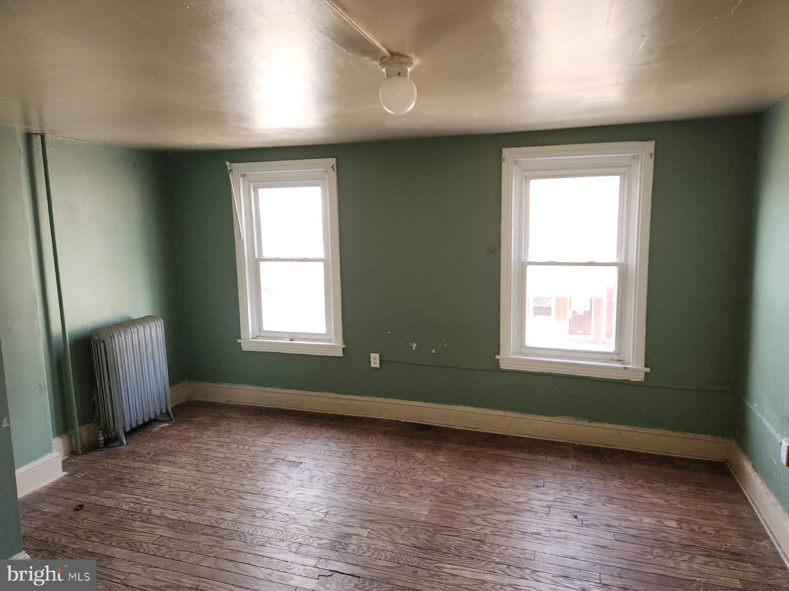 648 Kohn Street Norristown, PA 19401 - Photo 29 of 39 an empty room with wooden floor and windows