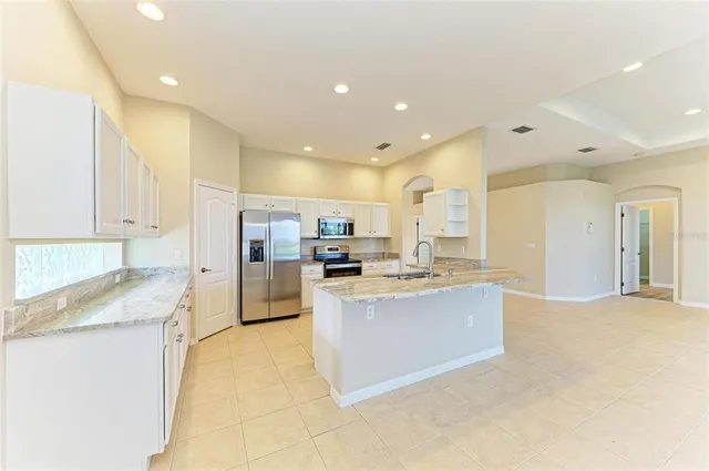 a spacious bathroom with a granite countertop sink a shower and a bathtub