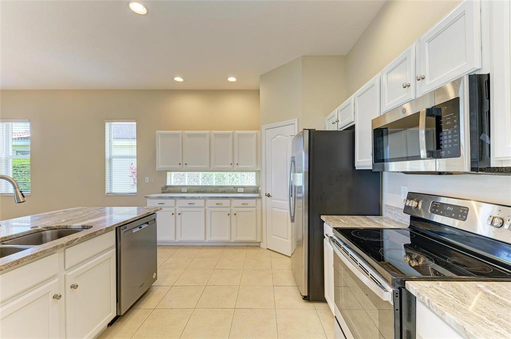 8772 Stone Harbour Loop Bradenton, FL 34212 - Photo 21 of 69 a kitchen with a sink stove and refrigerator