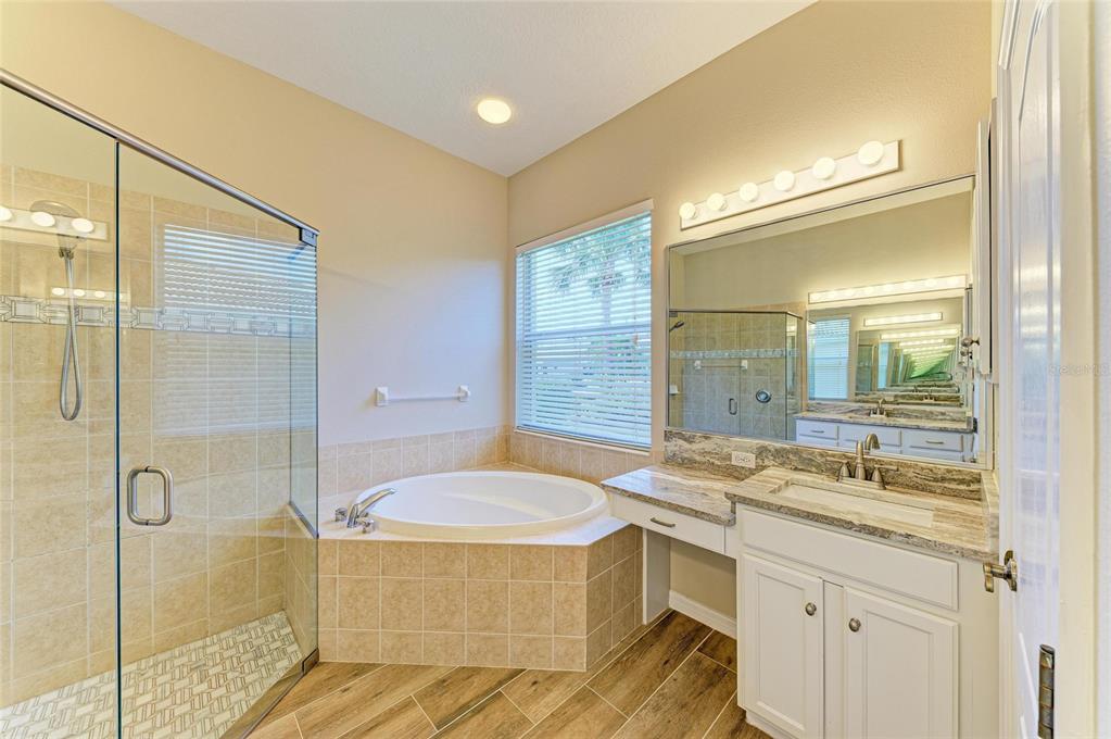 8772 Stone Harbour Loop Bradenton, FL 34212 - Photo 28 of 69 a bathroom with a tub sink and mirror