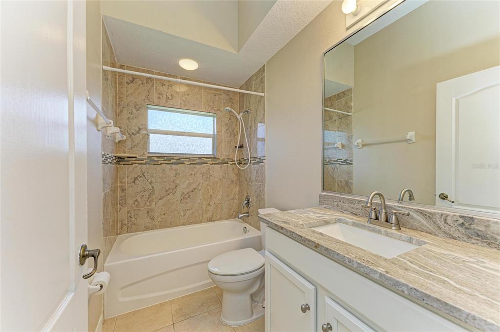 8772 Stone Harbour Loop Bradenton, FL 34212 - Photo 35 of 69 a bathroom with a granite countertop sink toilet and shower