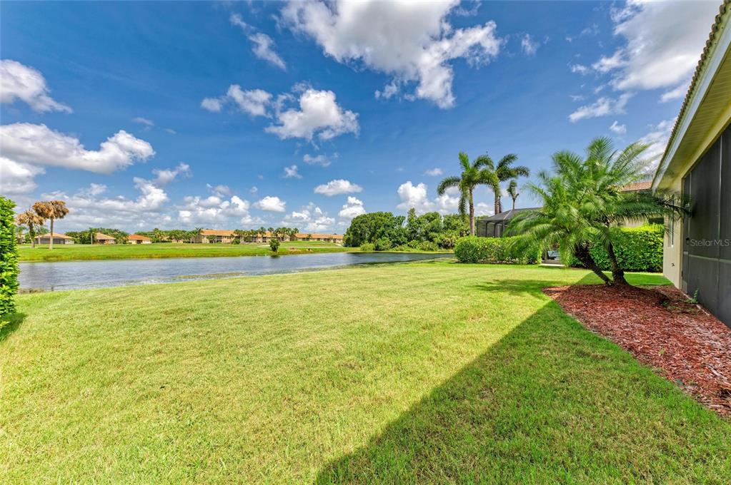 8772 Stone Harbour Loop Bradenton, FL 34212 - Photo 45 of 69 a view of a big yard with swimming pool and green space