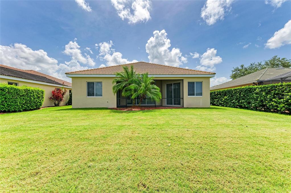 8772 Stone Harbour Loop Bradenton, FL 34212 - Photo 47 of 69 a front view of a house with garden