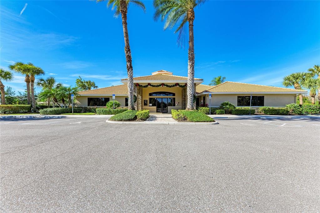 8772 Stone Harbour Loop Bradenton, FL 34212 - Photo 62 of 69 a front view of a house with small garden and trees