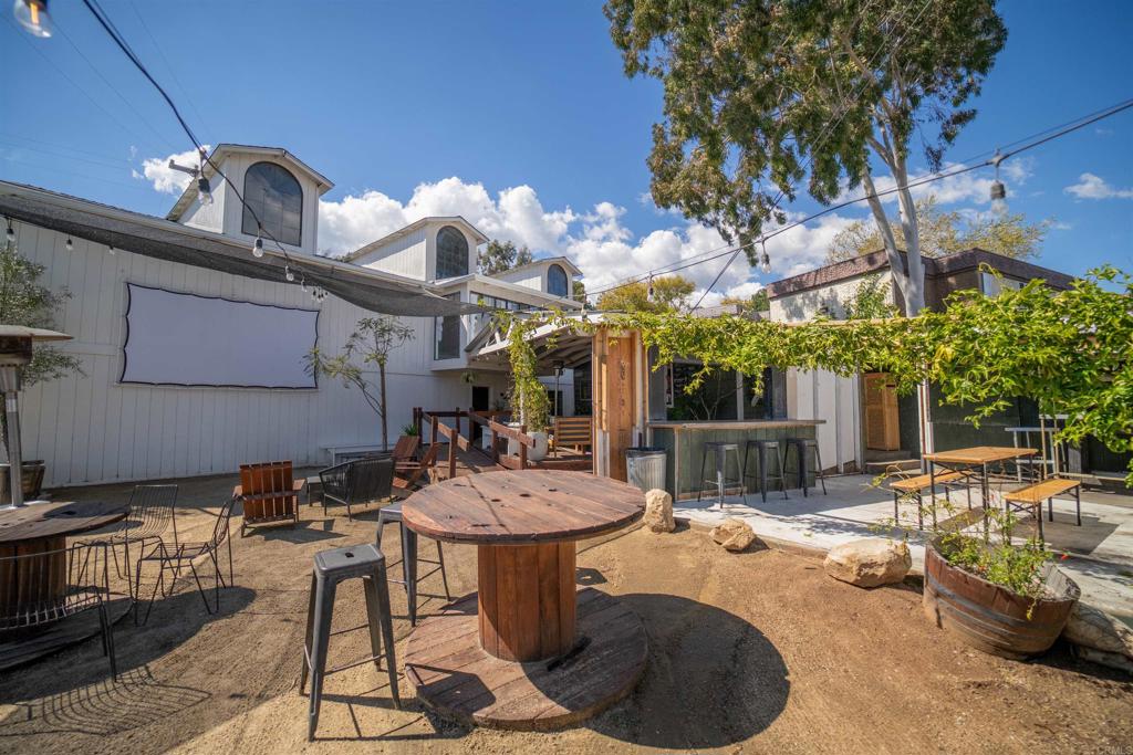838 East Mission Road Fallbrook, CA 92028 - Photo 33 of 49 a view of a patio with table and chairs potted plants and a large tree