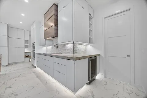 a bathroom with a granite countertop sink a mirror and shower