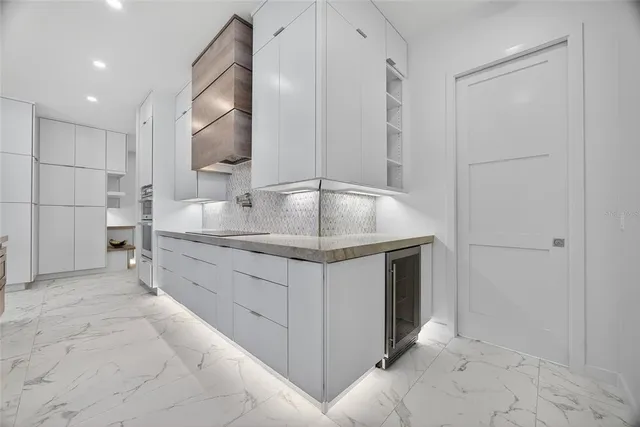 a bathroom with a granite countertop sink a mirror and shower
