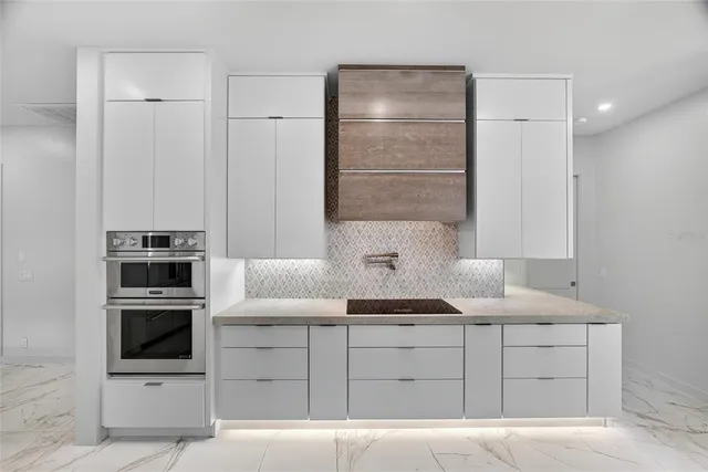 a kitchen with a refrigerator sink and cabinets
