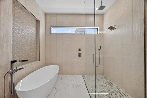 a bathroom with a tub and shower