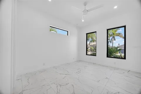 an empty room with windows and closet