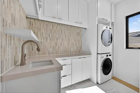 a bathroom with a sink and a washing machine