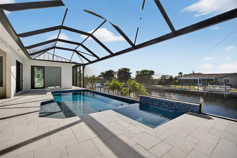 a swimming pool view with a seating space