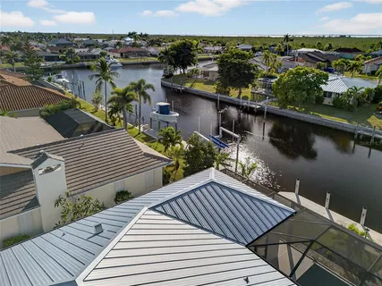 an aerial view of a house with garden space and lake view