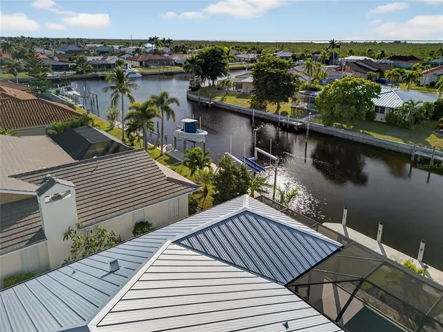 an aerial view of a house with garden space and lake view