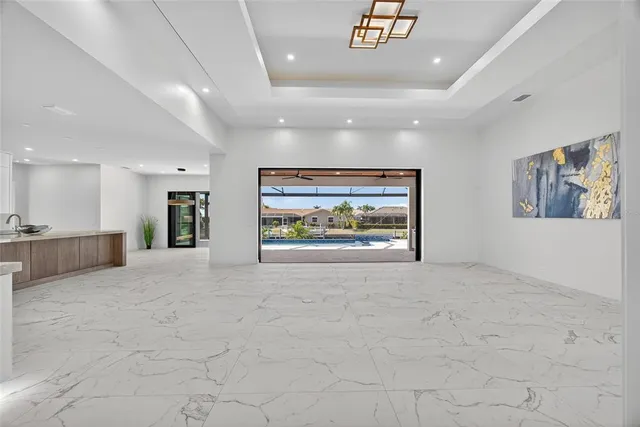 a view of an empty room with a painting on the wall