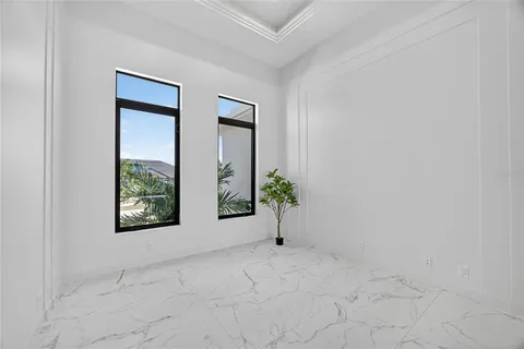 an empty room with windows and mirror