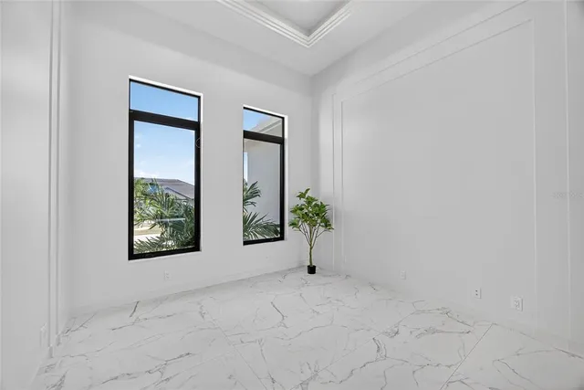 an empty room with windows and mirror