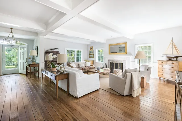 a living room with fireplace furniture and a wooden floor