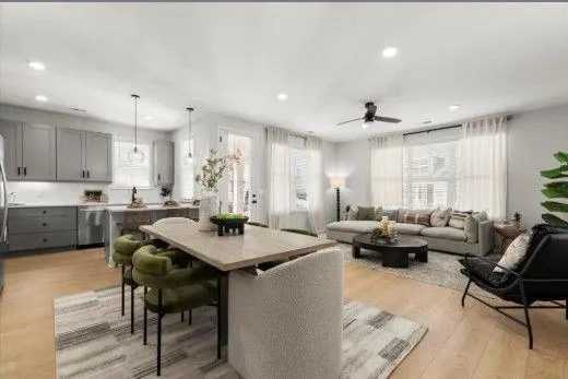 a kitchen with a dining table chairs and view living room