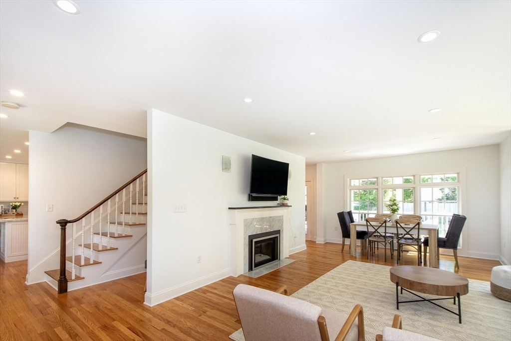 584 Hatherly Road Scituate, MA 02066 - Photo 16 of 42 a living room with furniture a fireplace and a flat screen tv