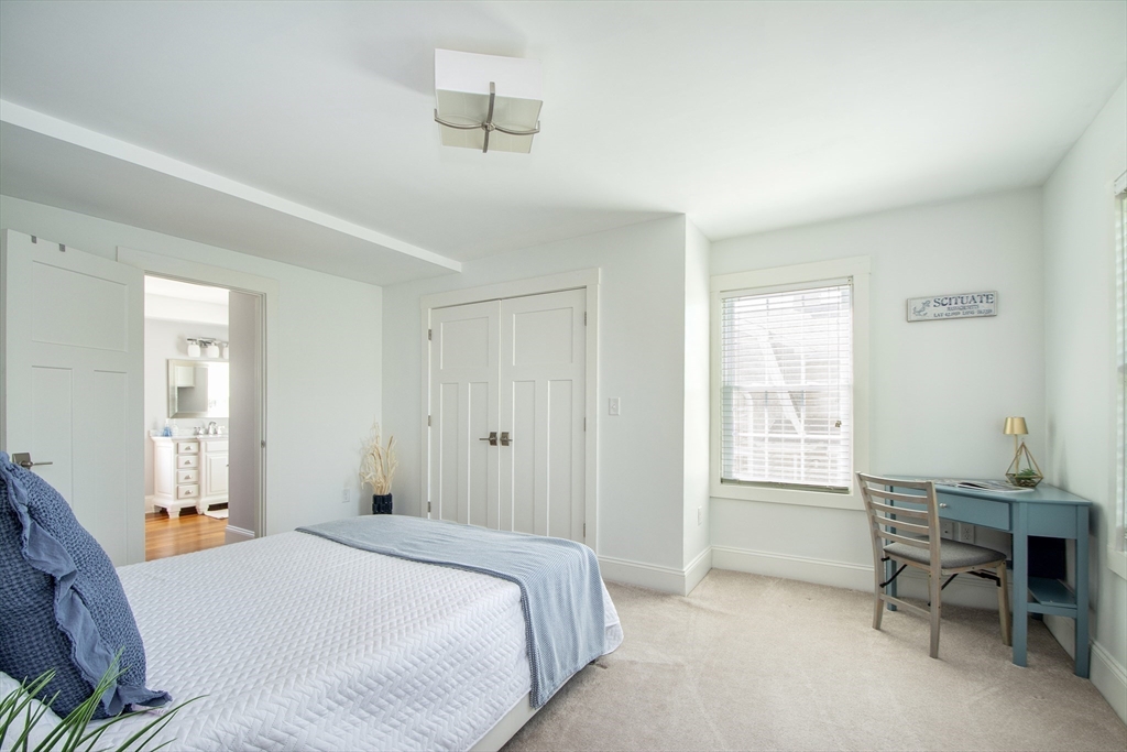 584 Hatherly Road Scituate, MA 02066 - Photo 21 of 42 a bedroom with a bed and a window