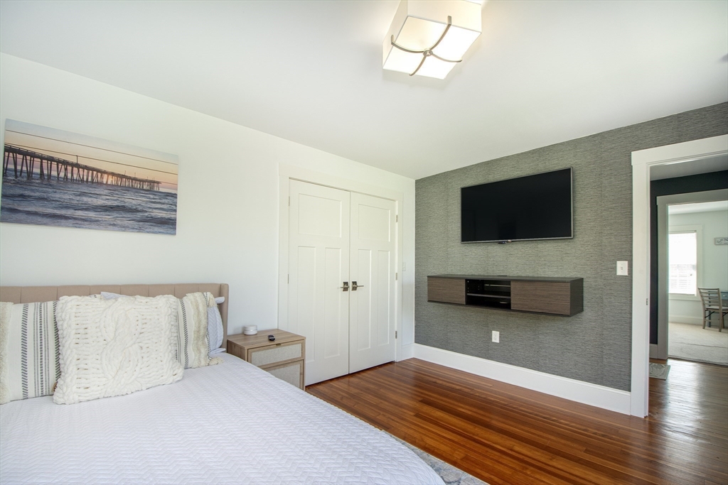 584 Hatherly Road Scituate, MA 02066 - Photo 24 of 42 a bedroom with furniture and flat screen tv