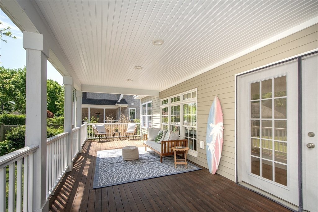 584 Hatherly Road Scituate, MA 02066 - Photo 35 of 42 a living room with furniture floor to ceiling window and wooden floor