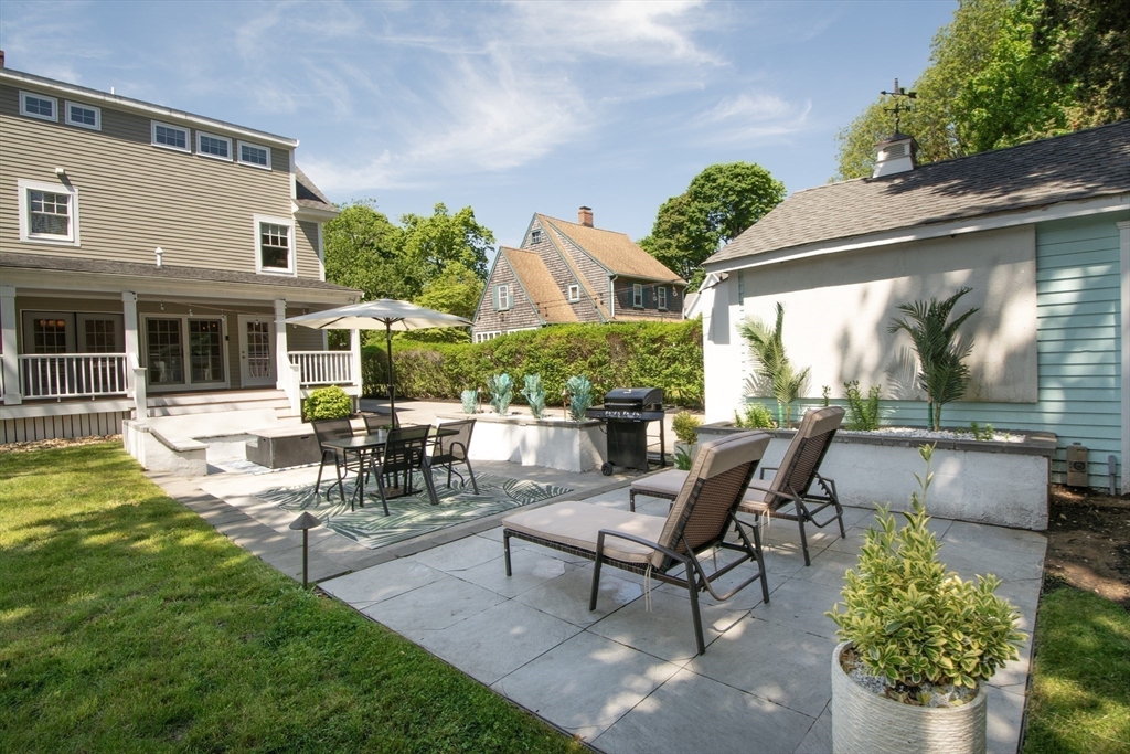 584 Hatherly Road Scituate, MA 02066 - Photo 37 of 42 a view of a patio with table and chairs and potted plants