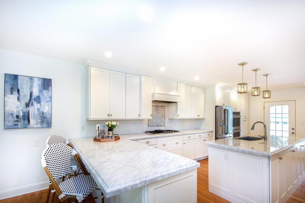 584 Hatherly Road Scituate, MA 02066 - Photo 9 of 42 a open kitchen with stainless steel appliances granite countertop a sink stove and cabinets