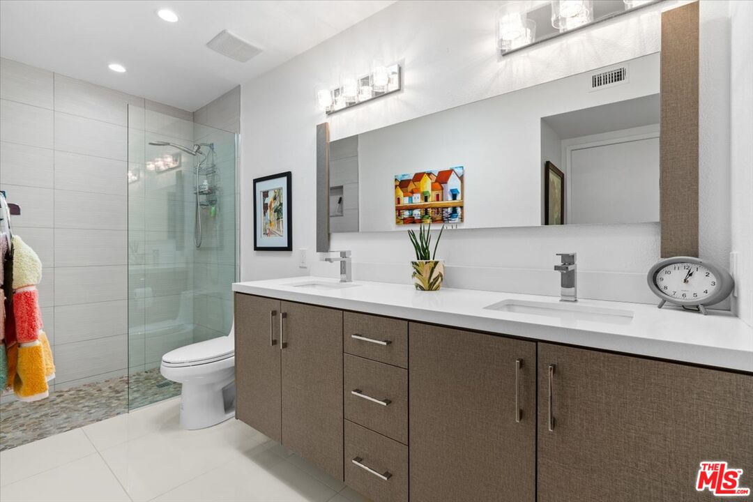 1111 East Ramon Road, Unit 17 Palm Springs, CA 92264 - Photo 11 of 34 a bathroom with a toilet sink and mirror