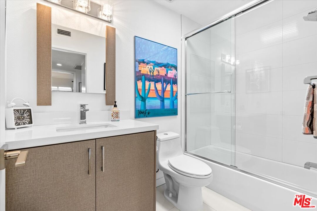 1111 East Ramon Road, Unit 17 Palm Springs, CA 92264 - Photo 14 of 34 a bathroom with a sink a toilet and shower