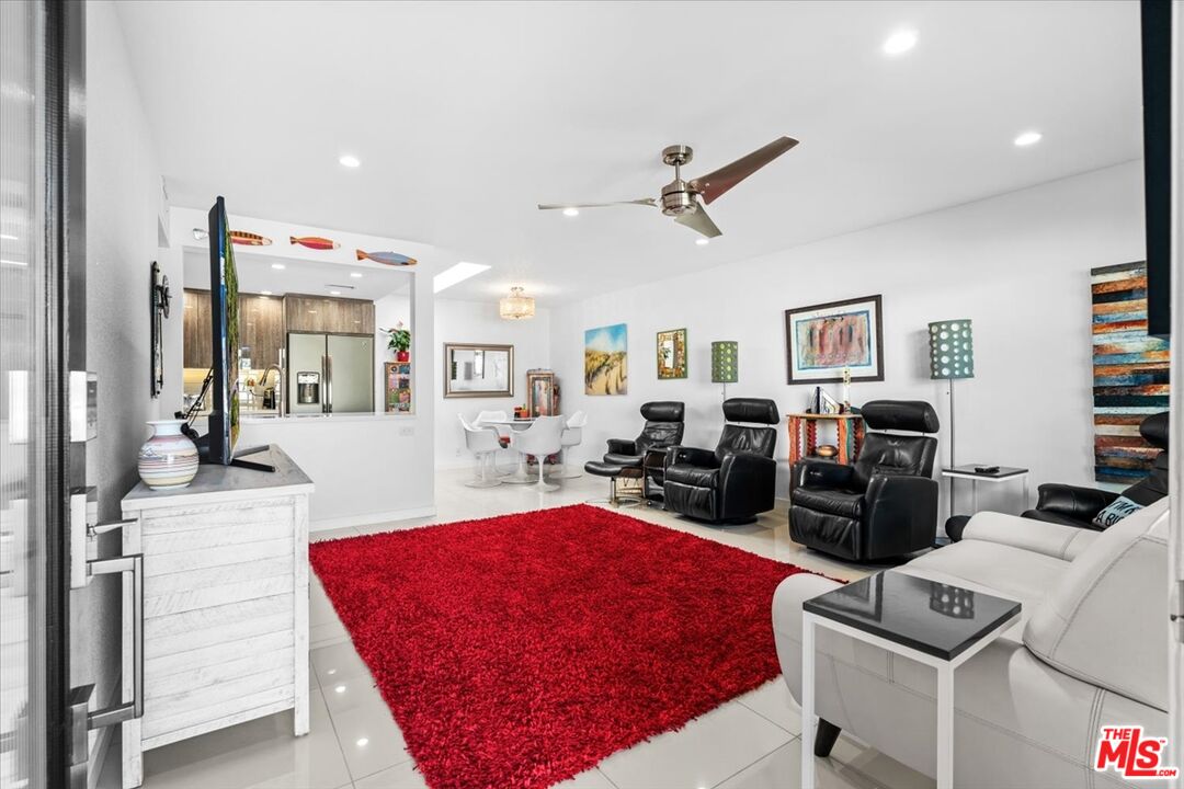 1111 East Ramon Road, Unit 17 Palm Springs, CA 92264 - Photo 2 of 34 a living room with furniture a rug and white walls