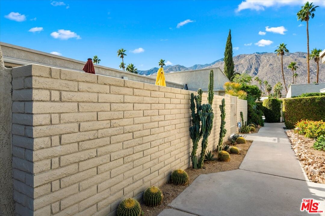 1111 East Ramon Road, Unit 17 Palm Springs, CA 92264 - Photo 22 of 34 a view of a pathway with an buildings in the background