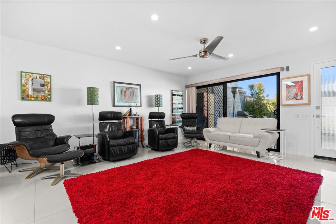 1111 East Ramon Road, Unit 17 Palm Springs, CA 92264 - Photo 3 of 34 a living room with furniture and a flat screen tv