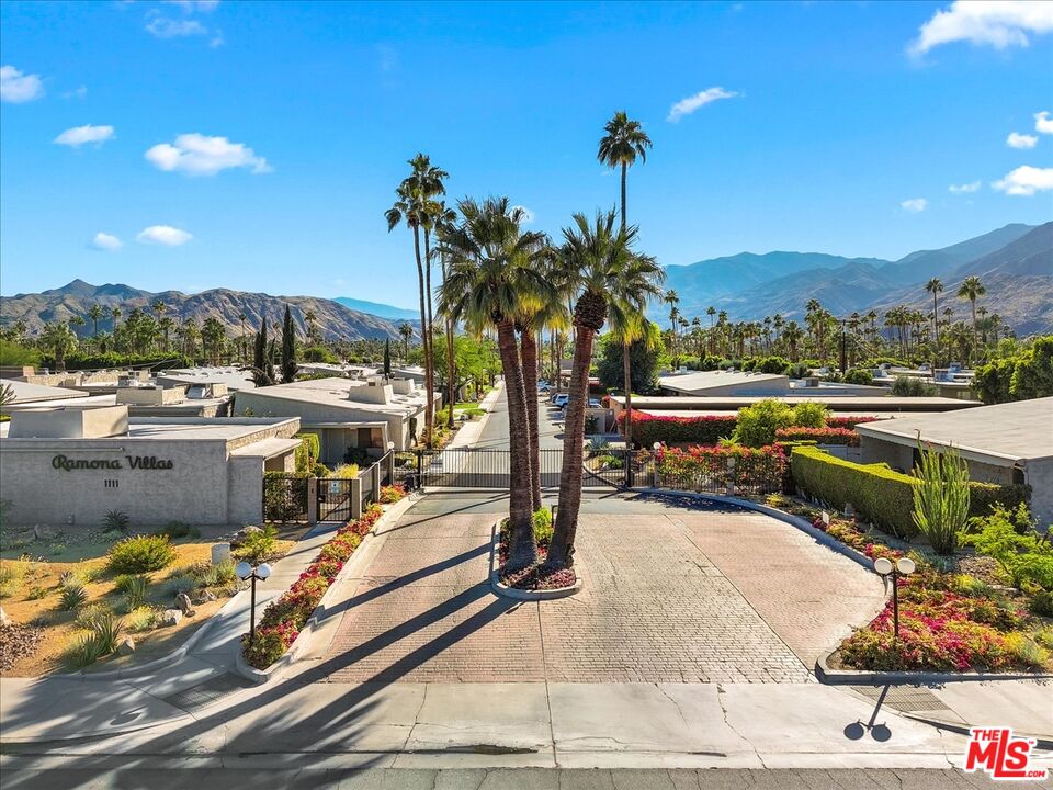 1111 East Ramon Road, Unit 17 Palm Springs, CA 92264 - Photo 34 of 34 a view of a swimming pool with a table and chairs